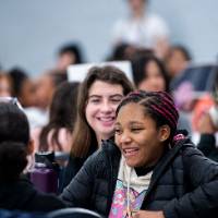 Girls of Color Summit previous event with a student giggling with friends